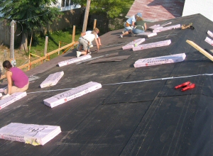 Habitat Volunteers installing shingles Habitat Volunteers installing shingles
